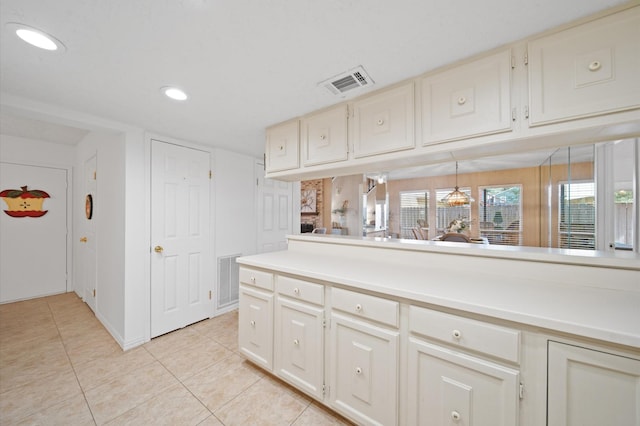 kitchen with white cabinetry and light tile patterned floors