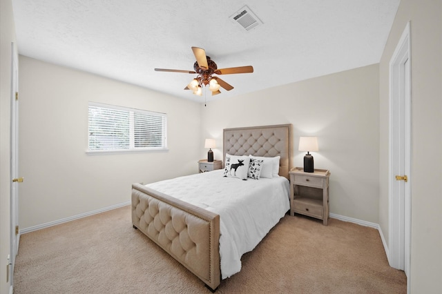 bedroom with light colored carpet and ceiling fan