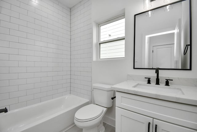 full bathroom featuring vanity, tiled shower / bath, and toilet