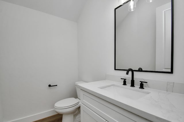 bathroom featuring vanity, hardwood / wood-style floors, and toilet