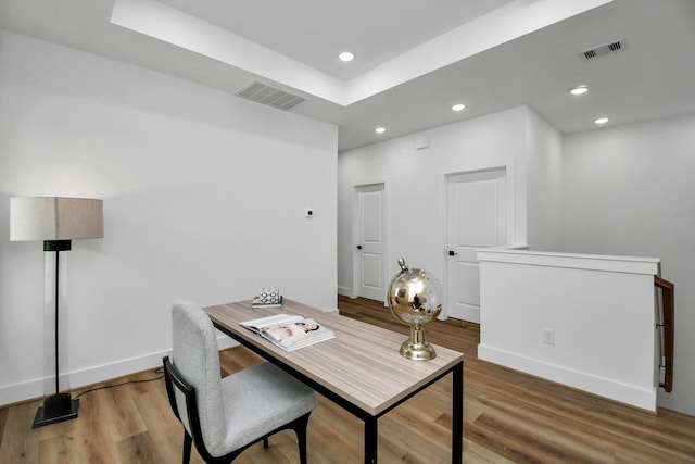 home office with wood-type flooring