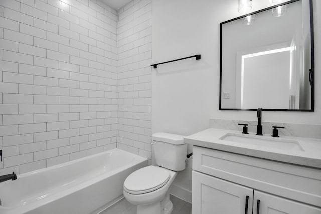 full bathroom featuring tiled shower / bath, vanity, and toilet