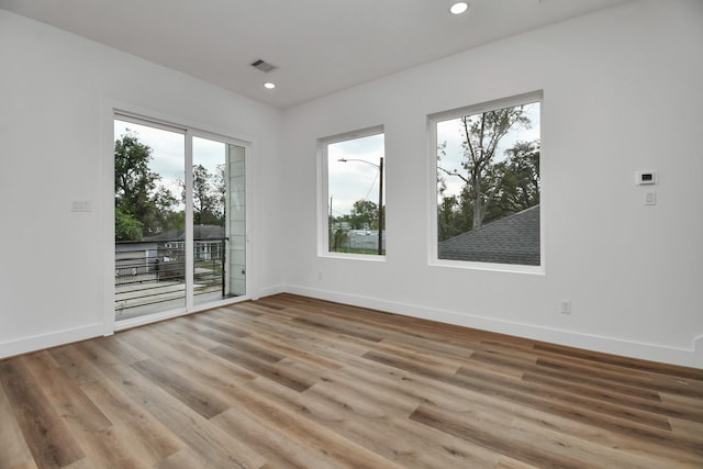 spare room with wood-type flooring