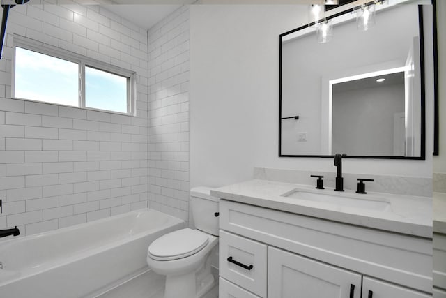 full bathroom featuring vanity, toilet, and tiled shower / bath combo