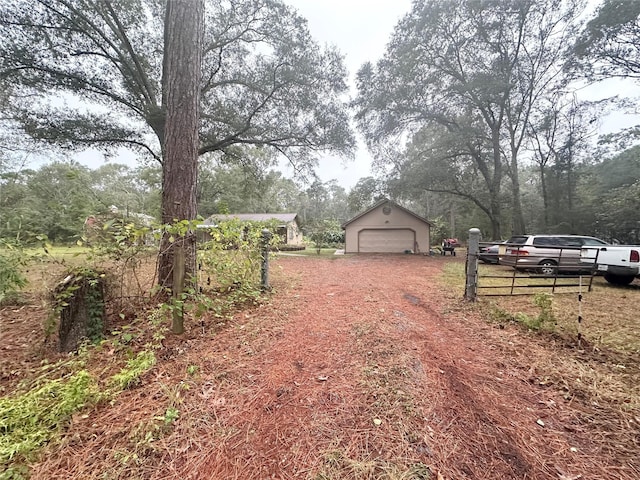 view of yard featuring an outbuilding and a garage