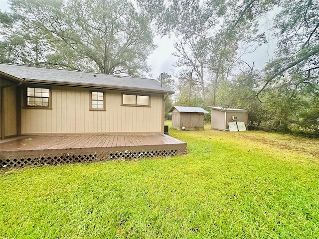 view of yard with a deck and a storage unit