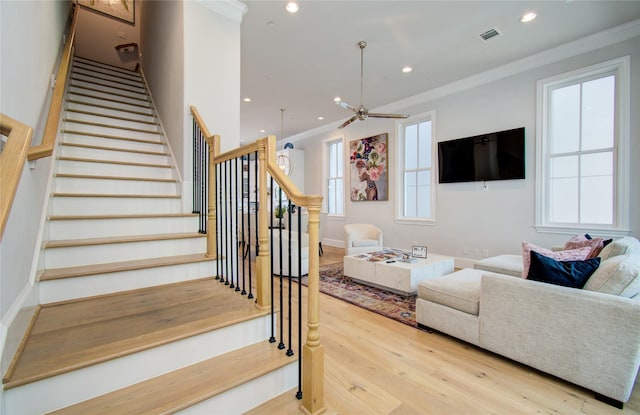 living room featuring light hardwood / wood-style flooring and ornamental molding