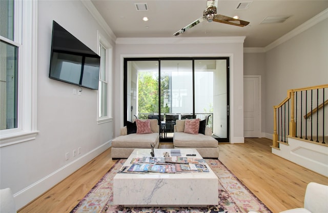 living room with ornamental molding, hardwood / wood-style floors, and ceiling fan