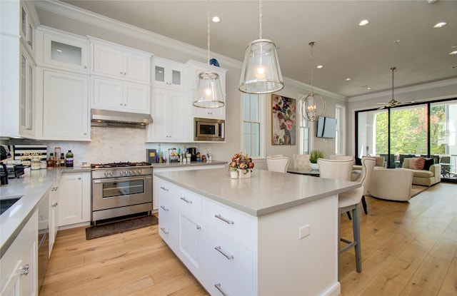 kitchen with a center island, stainless steel appliances, range hood, decorative backsplash, and white cabinets