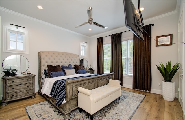 bedroom with ceiling fan, ornamental molding, and light hardwood / wood-style floors