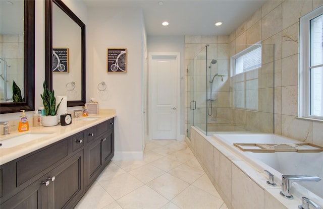 bathroom with shower with separate bathtub, plenty of natural light, vanity, and tile patterned floors