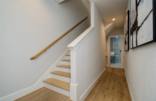 stairs featuring wood-type flooring