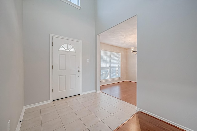 tiled entrance foyer featuring a high ceiling