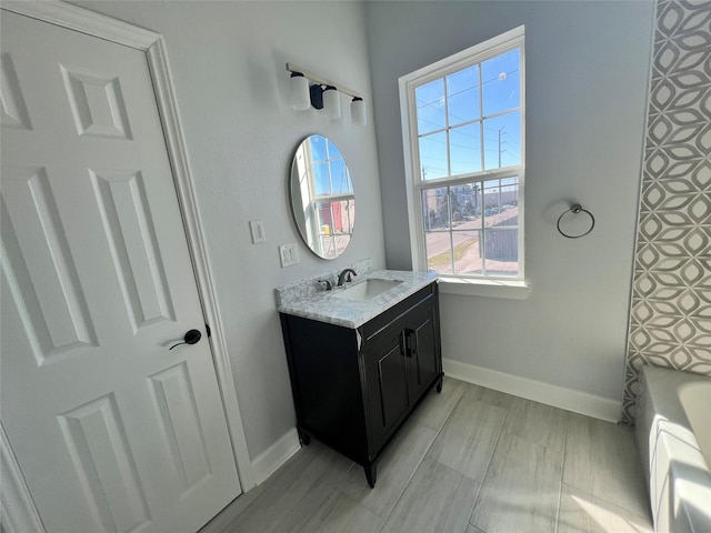 bathroom featuring vanity and a tub to relax in