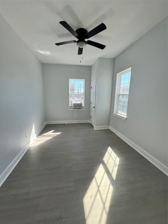 unfurnished room featuring ceiling fan, cooling unit, and dark hardwood / wood-style flooring