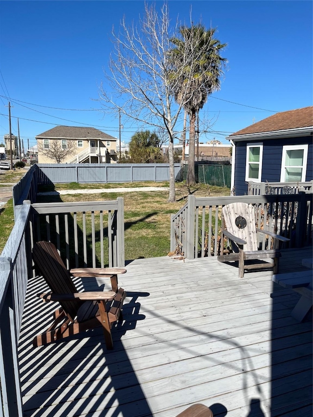 wooden deck featuring a lawn