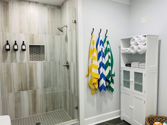 bathroom with tile patterned floors and a shower