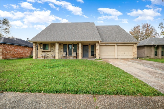 view of front of property with a porch, a garage, and a front lawn