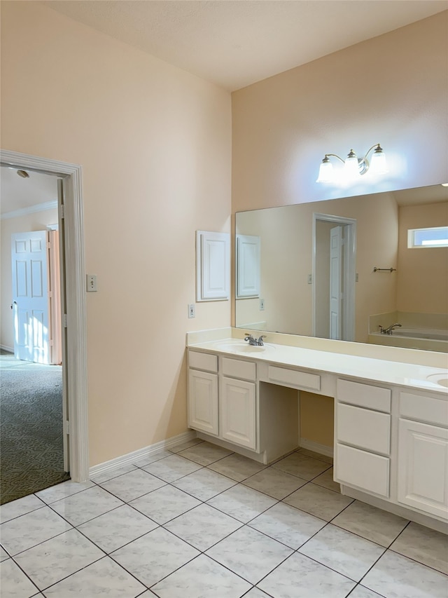 bathroom featuring tile patterned flooring, a bathing tub, and vanity