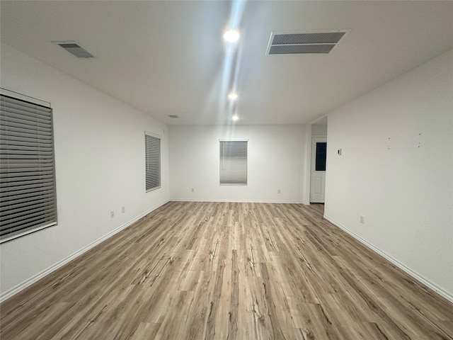 empty room with light hardwood / wood-style flooring