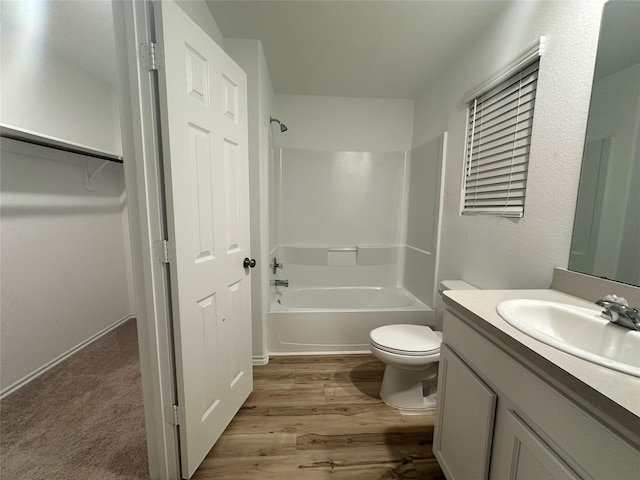 full bathroom with vanity, wood-type flooring,  shower combination, and toilet