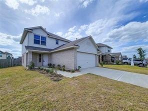 view of front of house featuring a garage and a front lawn