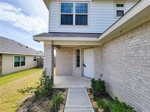 entrance to property featuring a patio