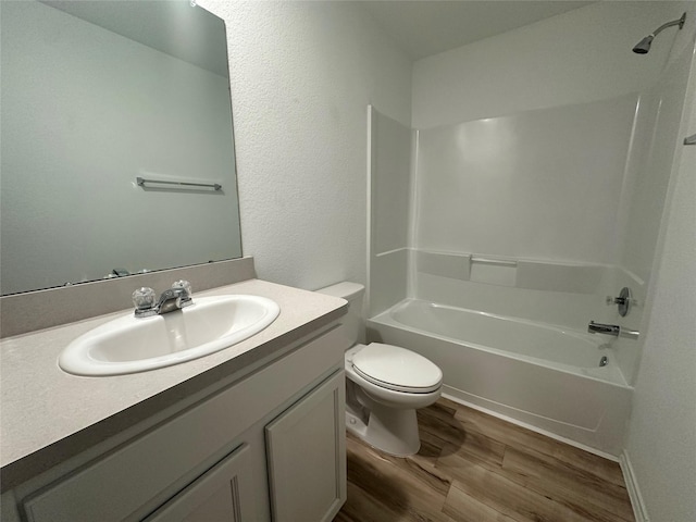 full bathroom with vanity, hardwood / wood-style floors, bathtub / shower combination, and toilet