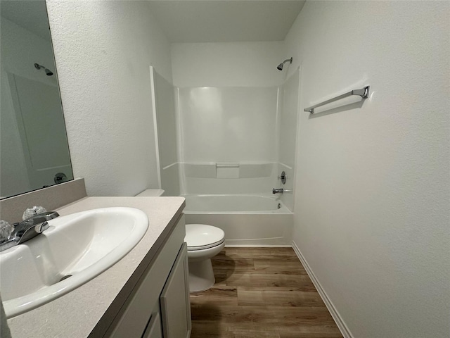 full bathroom featuring wood-type flooring, vanity,  shower combination, and toilet