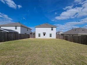 rear view of house featuring a lawn