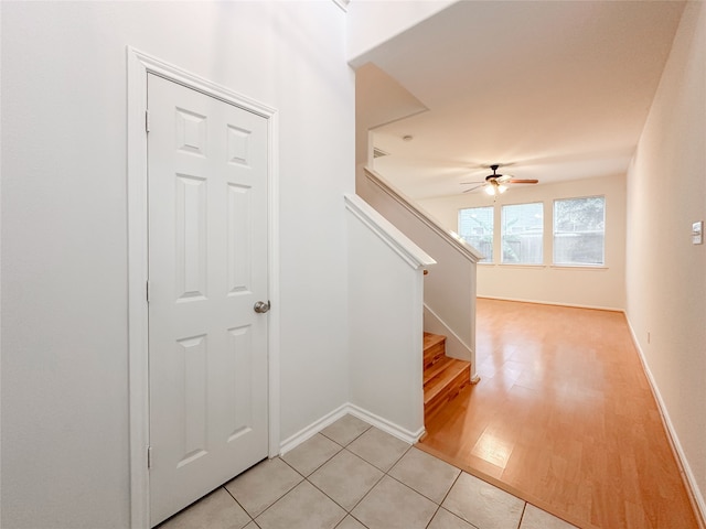 stairs featuring tile patterned floors and ceiling fan