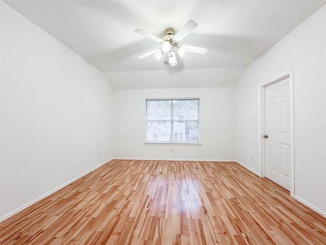 unfurnished room with vaulted ceiling, ceiling fan, and light wood-type flooring