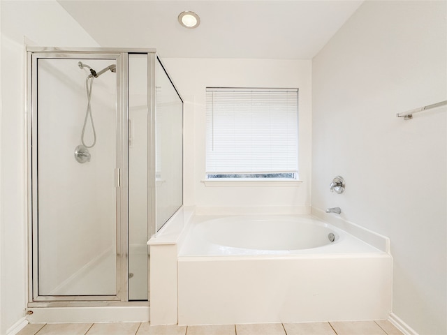 bathroom with plus walk in shower and tile patterned flooring