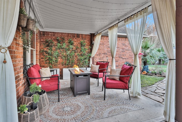 view of patio / terrace with an outdoor living space with a fire pit