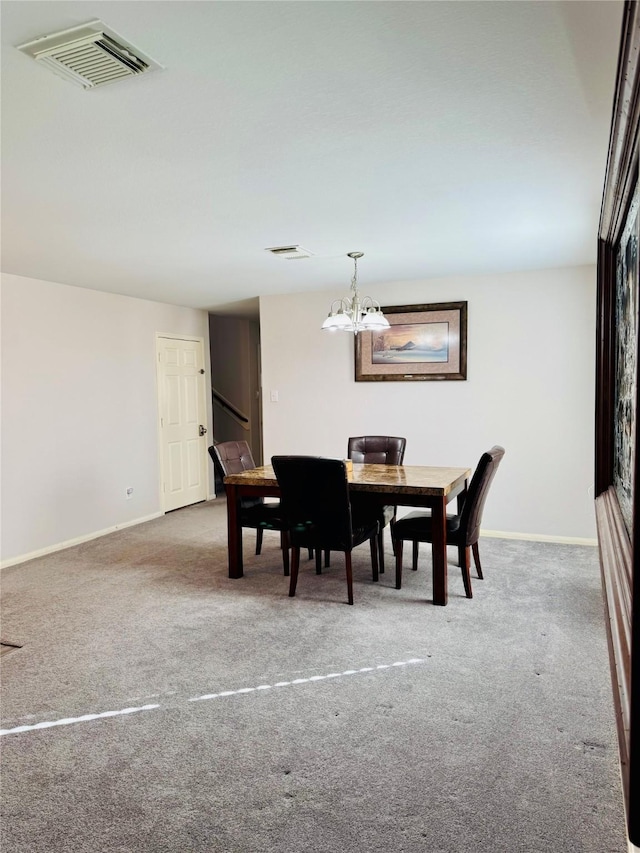 dining area with an inviting chandelier and carpet