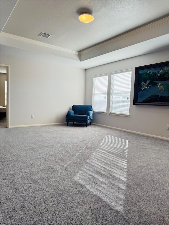 unfurnished room with light carpet, crown molding, a raised ceiling, and a textured ceiling