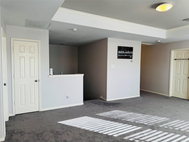 basement featuring ornamental molding and dark carpet