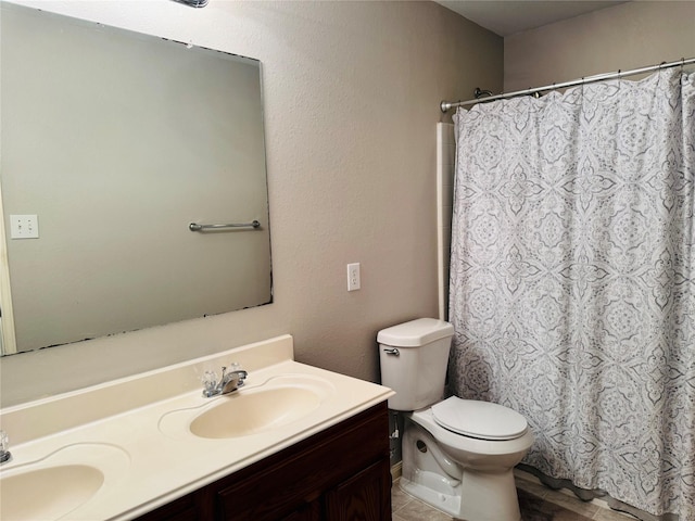 bathroom with vanity, toilet, and curtained shower