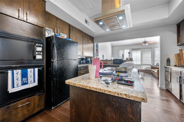 14323 Briarhills Pkwy, Houston, TX 77077 - kitchen featuring black appliances, extractor fan, dark wood-type flooring, a kitchen island, and ceiling fan