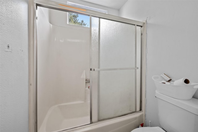 14323 Briarhills Pkwy, Houston, TX 77077 - full bathroom featuring toilet and shower / bath combination with glass door