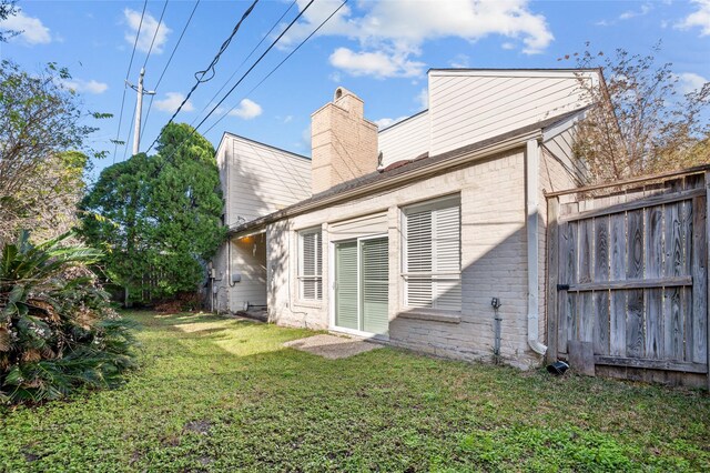 14323 Briarhills Pkwy, Houston, TX 77077 - rear view of house featuring a chimney and brick siding
