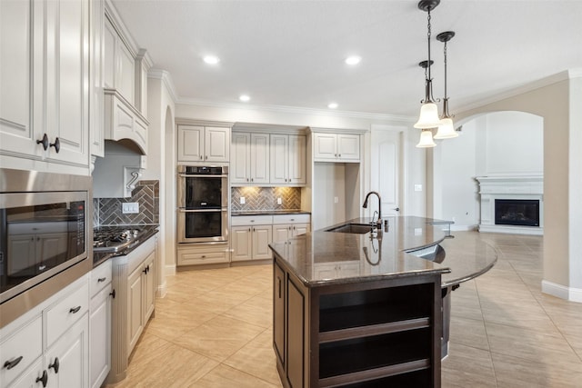 19031 Kimber Creek Ln, Cypress, TX 77429 - kitchen featuring a sink, stainless steel appliances, open shelves, crown molding, and arched walkways