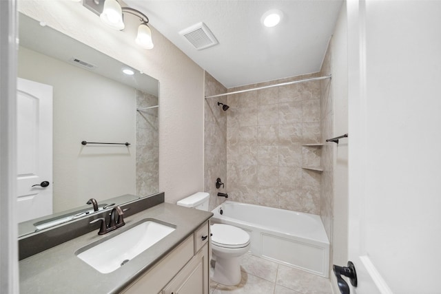 full bathroom featuring vanity, toilet, tiled shower / bath combo, and tile patterned flooring