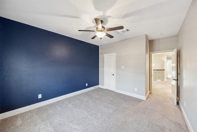 unfurnished bedroom featuring light carpet and ceiling fan