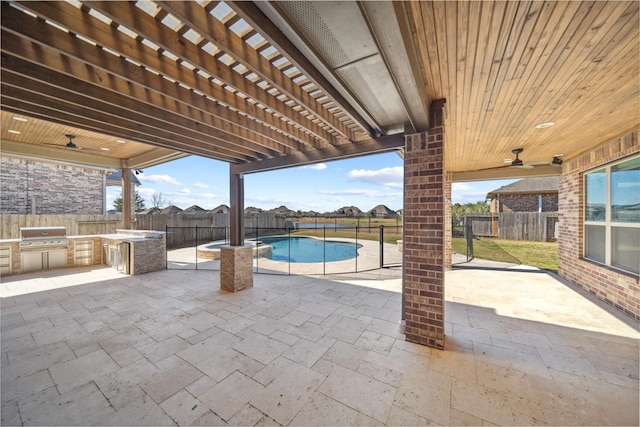 view of swimming pool featuring an outdoor kitchen, a pergola, area for grilling, and a patio