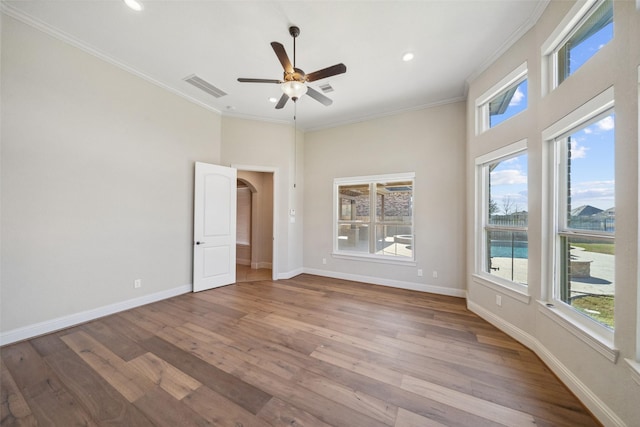 empty room featuring crown molding, ceiling fan, and light hardwood / wood-style flooring