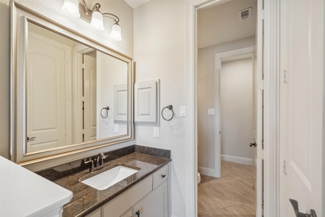 bathroom with vanity and toilet