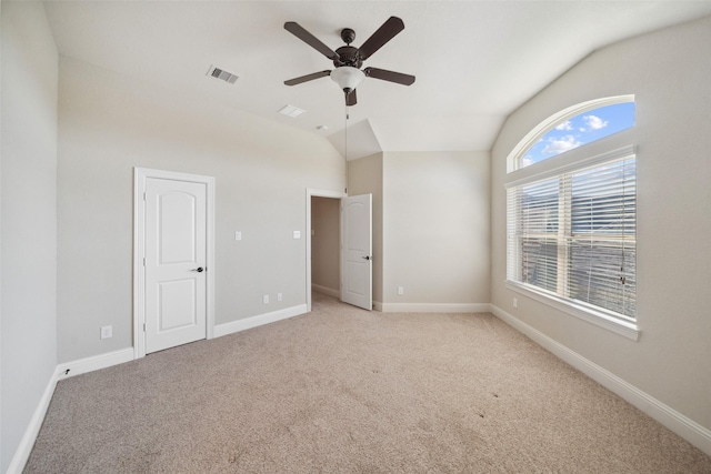 unfurnished bedroom with vaulted ceiling, light carpet, and ceiling fan