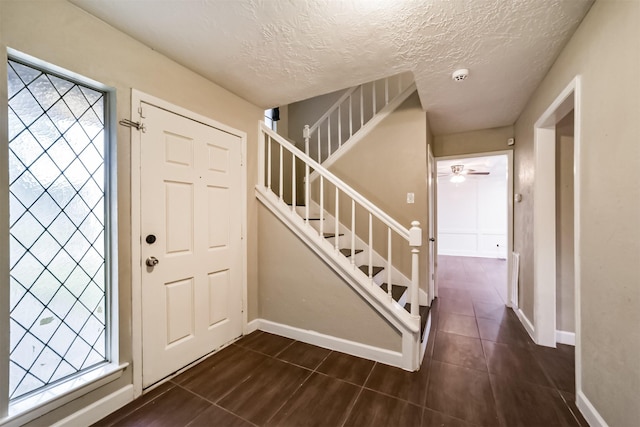 foyer entrance featuring a healthy amount of sunlight and a textured ceiling