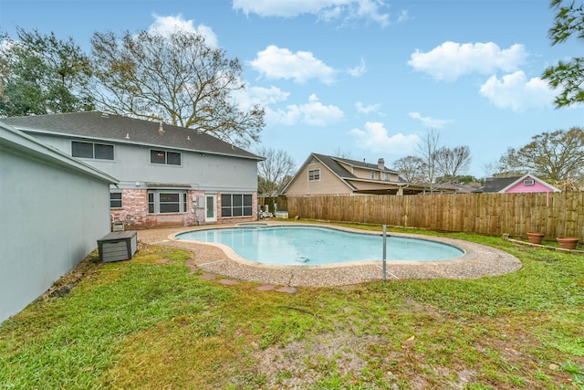 view of swimming pool featuring a yard